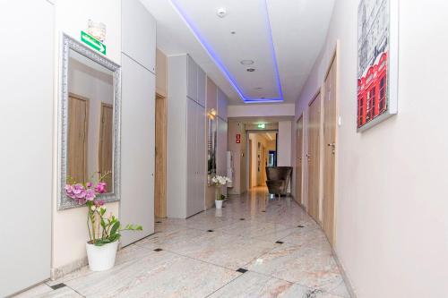 a hallway of a hospital with a blue ceiling at 3 City Hostel in Gdańsk