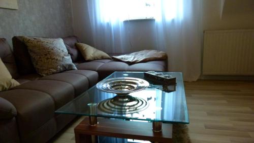 a living room with a couch and a glass table at Casa Maria App. Jose 1. Obergeschoss in Sankt Wendel