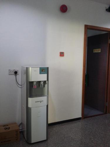a refrigerator in a room next to a door at Maxi Inn in Bintulu