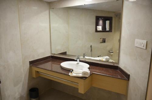 a bathroom with a sink and a mirror at Hotel Radiance in Bareilly