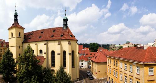 a church with a tower and a red roof at Hotel Hastal Prague Old Town in Prague