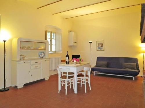 a living room with a table and a couch at Agriturismo La Moraia in Poggibonsi