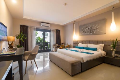 Ένα ή περισσότερα κρεβάτια σε δωμάτιο στο Damrei Angkor Hotel
