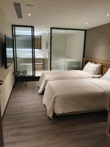 Ένα ή περισσότερα κρεβάτια σε δωμάτιο στο City Suites - Taoyuan Station
