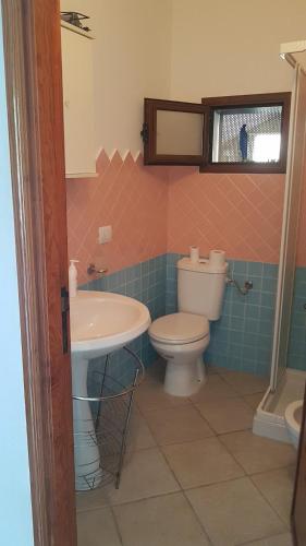 a bathroom with a toilet and a sink at Casa Terme Romane in Castelsardo