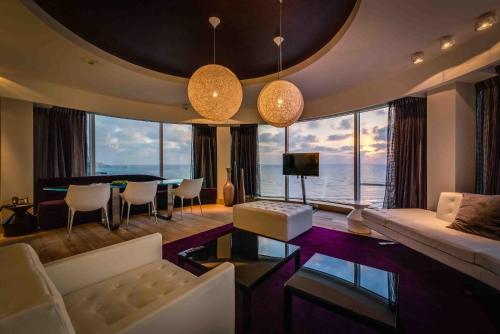 a living room with a couch and a table at Royal Beach Hotel Tel Aviv by Isrotel Exclusive in Tel Aviv