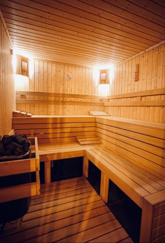 a large wooden sauna with a bench in it at Reverence Boutique Hotel in Varna City