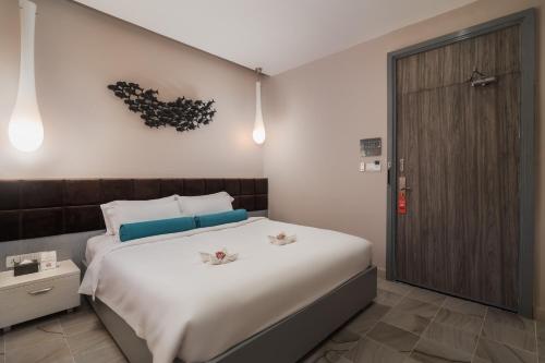 Ένα ή περισσότερα κρεβάτια σε δωμάτιο στο Damrei Angkor Hotel