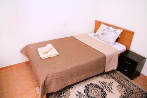 a bedroom with a bed with a towel on it at Comfortable House with Warm Hospitality in Katerini