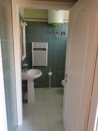 a bathroom with a sink and a toilet at Villaggio Turistico Airone in Riotorto
