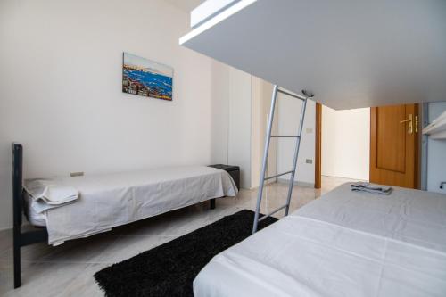 a bedroom with two beds and a ladder at Villa Salvius in Scafati