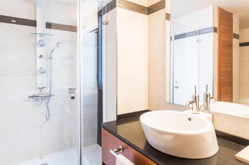 a bathroom with a sink and a shower at Majestic Hotel & Spa Barcelona GL in Barcelona