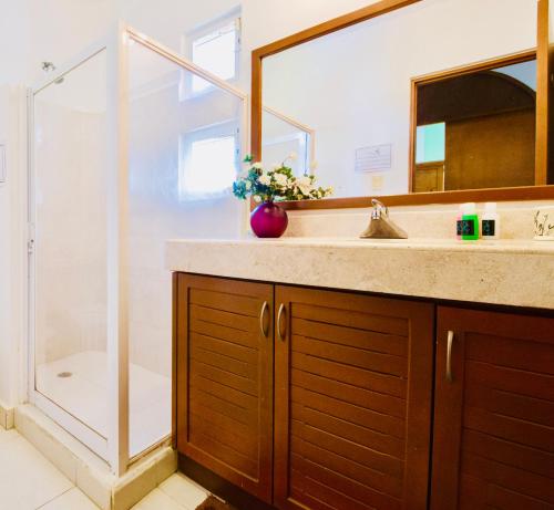 a bathroom with a sink and a shower at Deluxe Family Budget Balcony Room with Pool Playacar Ii in Playa del Carmen