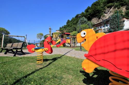 a park with a playground with a play equipment at Hotel Oasi Verde in Bienno