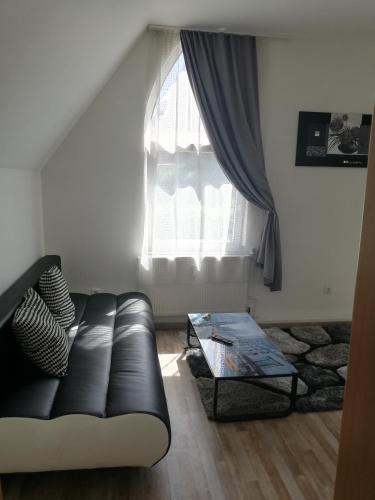 a living room with a couch and a window at Pension da Alessandro in Hemer