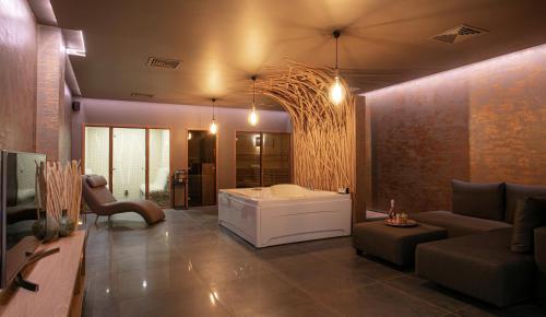 a living room with a tub and a couch at Reverence Boutique Hotel in Varna City