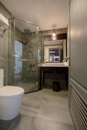 a bathroom with a shower and a toilet and a sink at Souphattra Hotel Luang Prabang in Luang Prabang