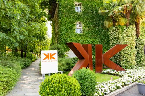 a sign in front of a ivy covered building at Casa Bianca Apartments in Como