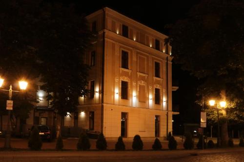 a large building with lights on it at night at Hotel Gal in Tarnów