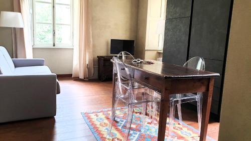 a living room with a wooden table and chairs at Villa Ottocento in Campertogno