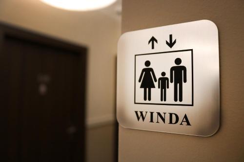 a sign on the wall of a room with a family at Hotel Gal in Tarnów