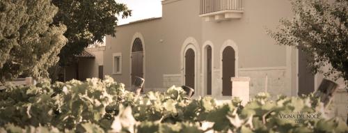 a building with a bunch of flowers in front of it at Tenuta Vigna del Noce in Corato