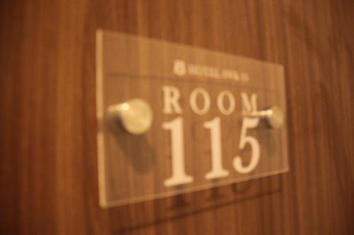 a sign on a door that says room at SWK 95 Hotel in Surabaya