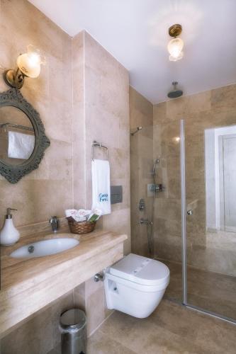 a bathroom with a toilet and a sink and a shower at Cunda Fora Hotel in Ayvalık