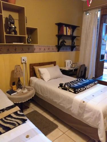 Postel nebo postele na pokoji v ubytování Protea B&B