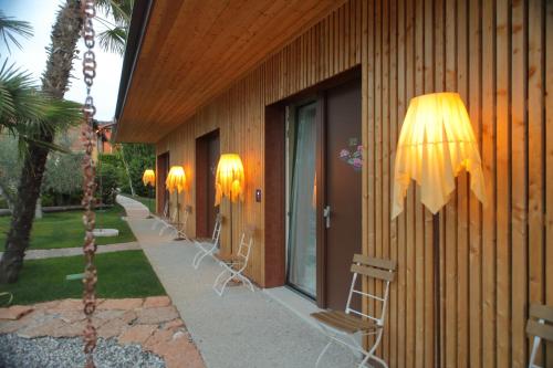 a row of chairs on the side of a building at La Boheme Chambres in Lazise