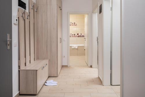 a hallway of a bathroom with a sink and a toilet at Brasov Holiday Apartments in Braşov