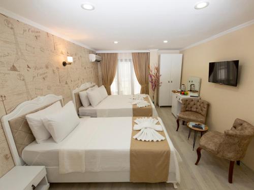 a hotel room with two beds and a tv at Vander Valk İstanbul Hotel in Istanbul