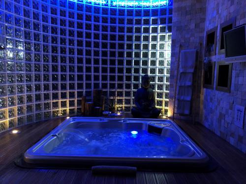 a jacuzzi tub in a room with blue lights at Quinta Da Bela Vista in Ponta Delgada