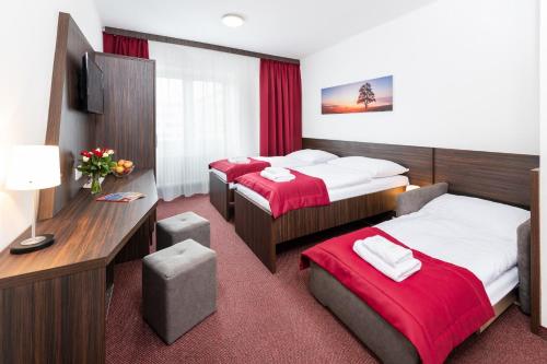 Cama o camas de una habitación en Hotel Plus