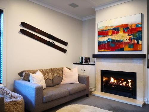 a living room with a couch and a fireplace at Cardrona Holiday Villa in Cardrona