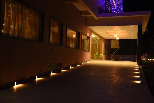 a building with lights on the side of it at night at Rathna Residency in Erode