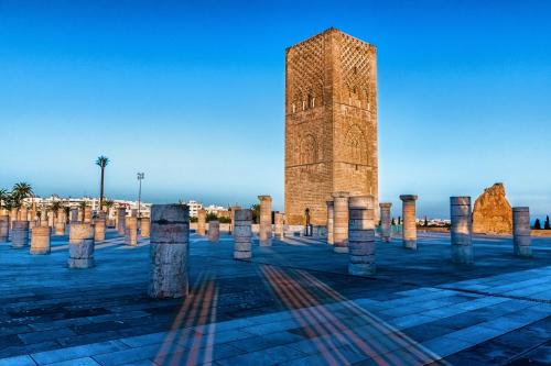 a tall clock tower in a square with stone pillars at Mercure Shéhérazade Rabat in Rabat