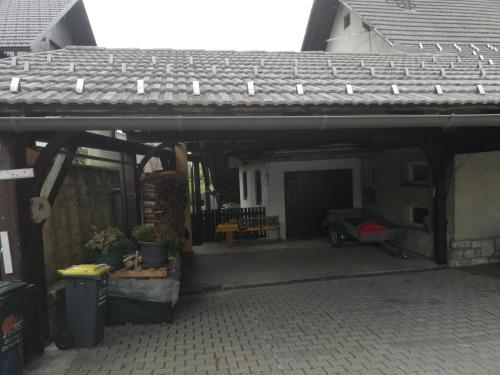 een terras met een dak en een garage bij Apartment Sopar in Škofja Loka