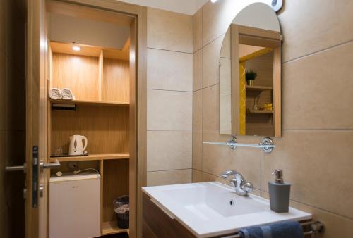 a bathroom with a sink and a mirror at Szent Anna Panzió in Esztergom