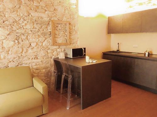 a kitchen with a counter and a bar with a microwave at Villa Ottocento in Campertogno