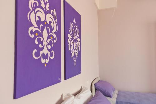 a room with two purple and white paintings on the wall at B&B Mamma Carolina in Sanarica