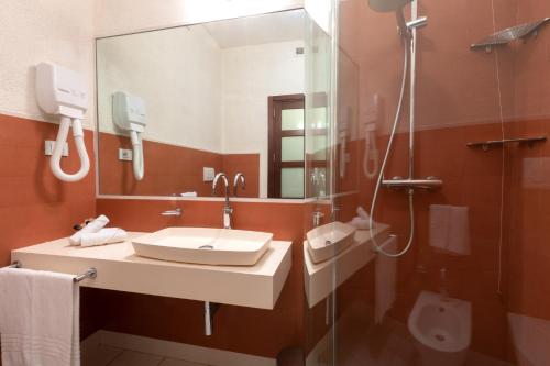 a bathroom with a sink and a shower at Gallipoli Resort in Gallipoli