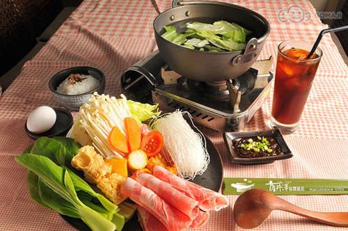 a table with a plate of food and a bowl of salad at Sun Moon Lake Karuizawa Villa in Yuchi