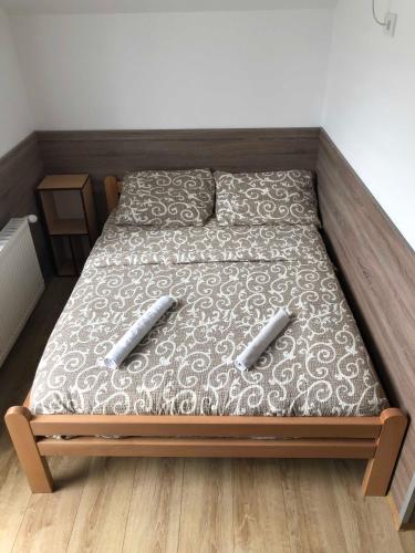 a bed with two pillows on it in a bedroom at Vila Zlatarka in Nova Varoš