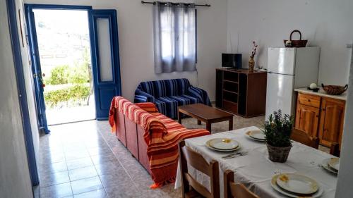 a living room with a couch and a table at Irene Family Apartment in Symi