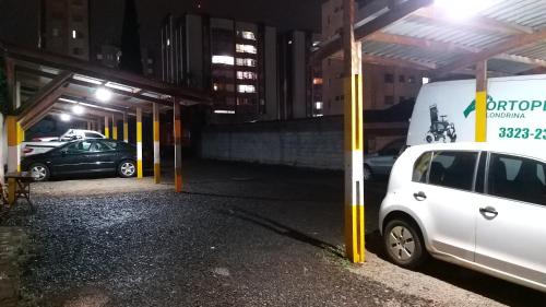 a white car parked in a parking lot at night at Hotel Donna Linda in Londrina