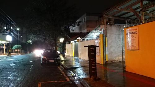 a car parked on the side of a street at night at Hotel Donna Linda in Londrina