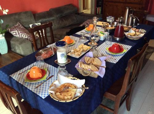 a table with a blue table cloth with food on it at B&B Luce Viola in Dorgali
