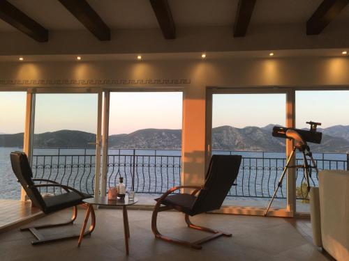 a room with two chairs and a view of the water at THE VIEW **** in Račišće