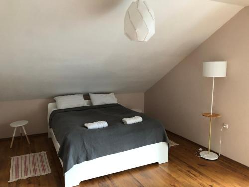 a bedroom with a bed with two towels on it at Dom Sówka in Radzyń